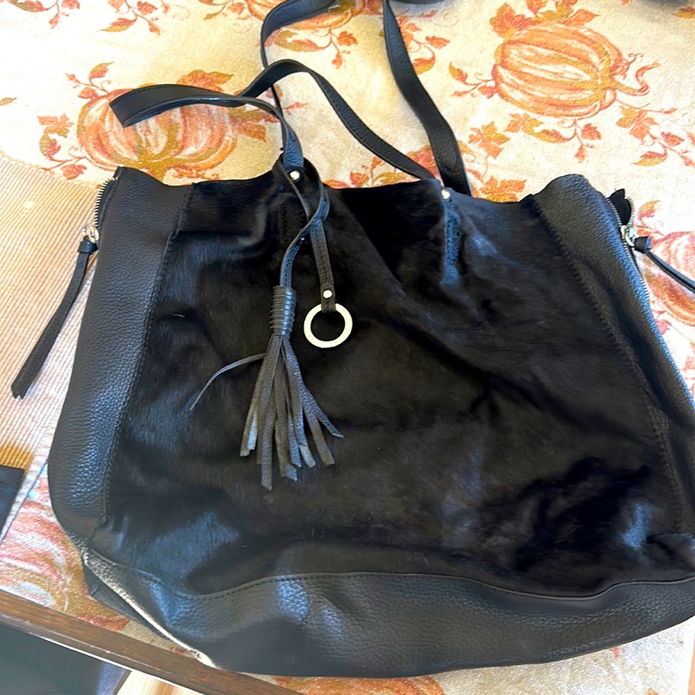 Black purse leather front has like cow hair